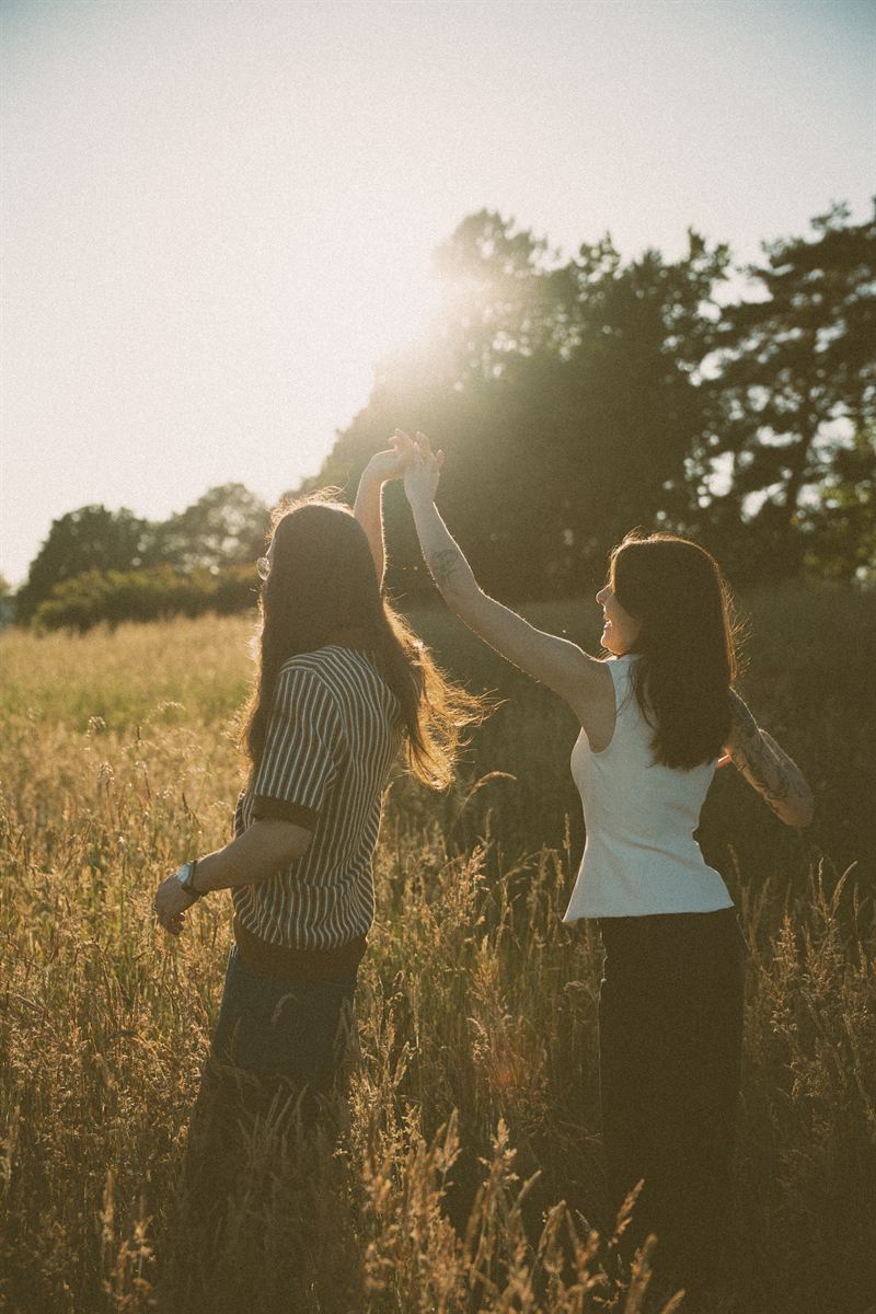 He spins her through a golden Garry oak meadow on Vancouver Island, backlit by the evening sun