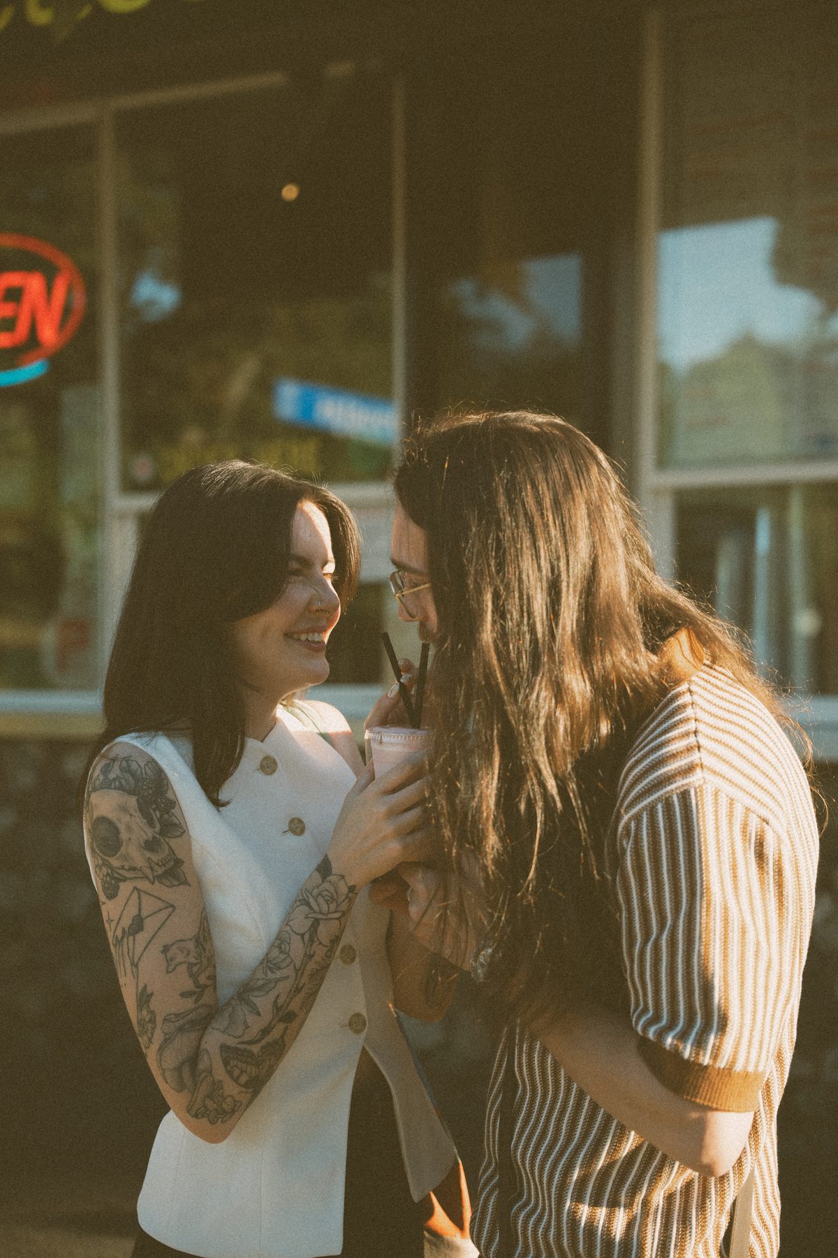 Sharing a milkshake outside a Victoria diner, both of them laughing in the late sun