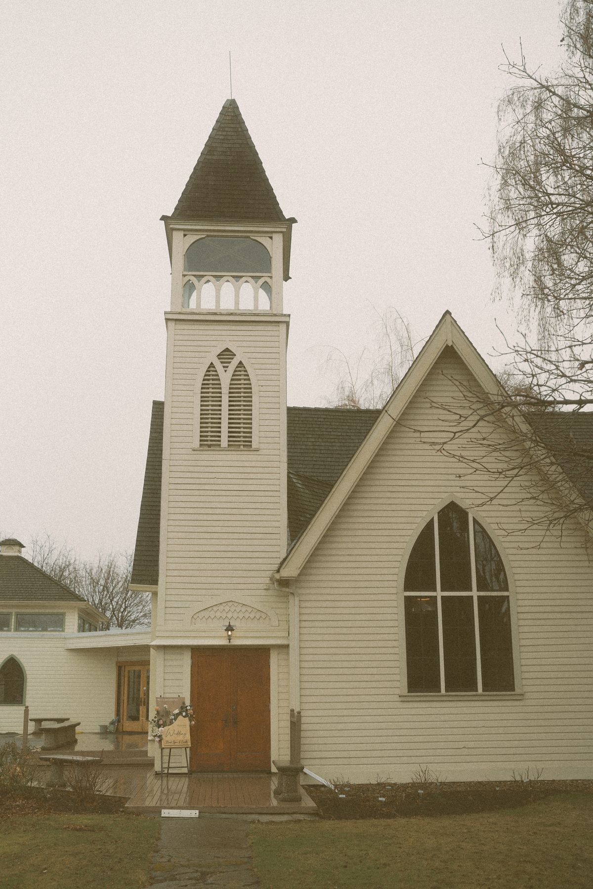 The historic white Benvoulin Heritage Church and steeple on an early-spring afternoon