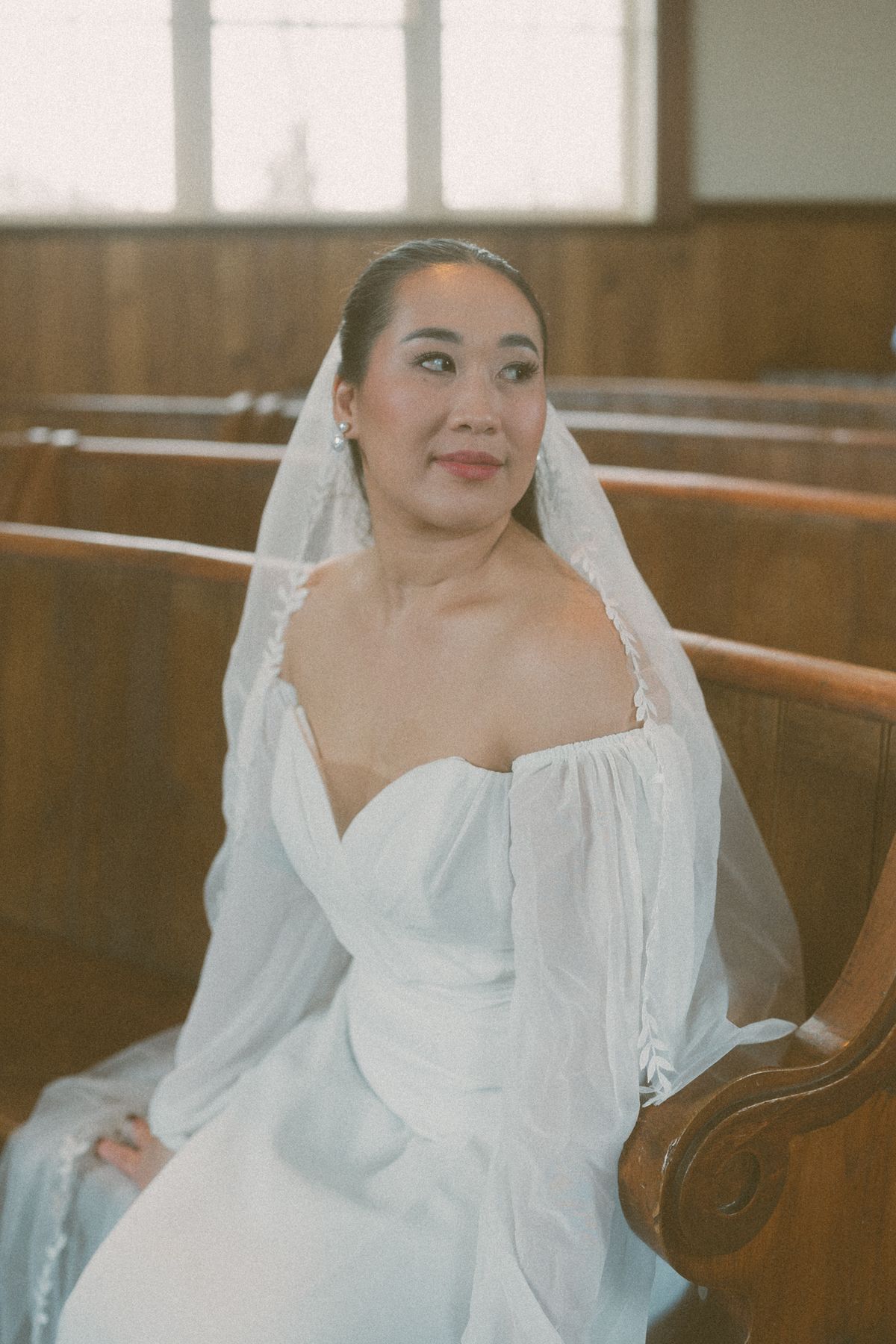 Quiet portrait of the bride in the church pew