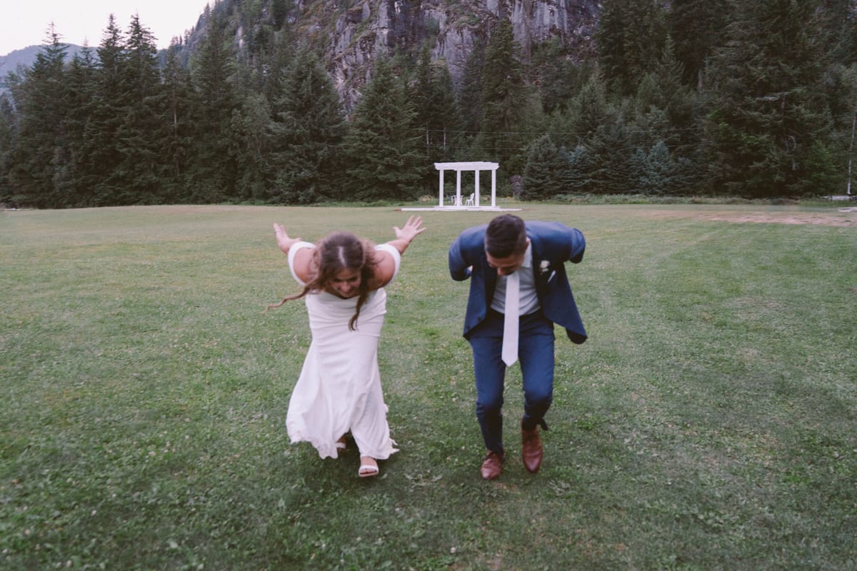 A playful moment as Kendra and Rory throw their arms up in the meadow by the gazebo