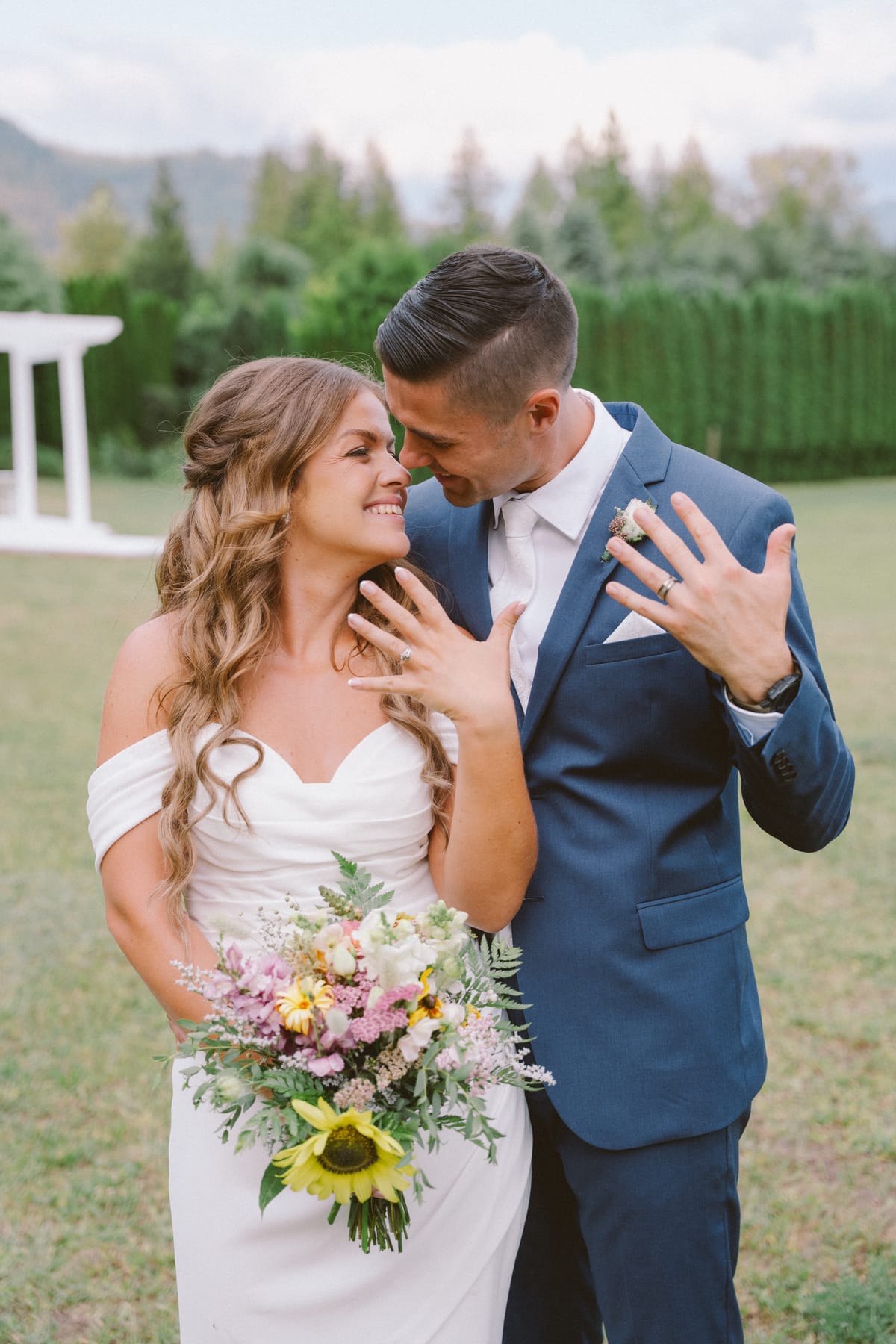 Kendra and Rory forehead to forehead, showing off their wedding rings