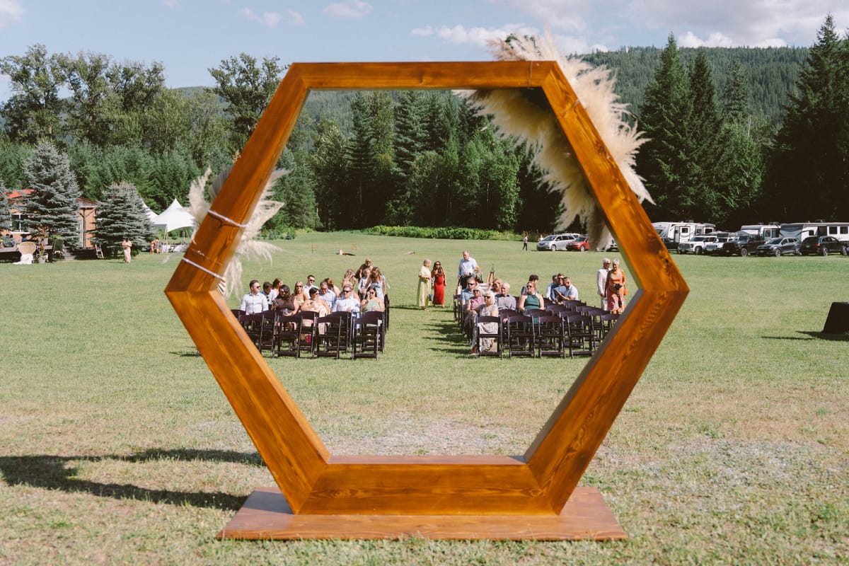 The reception tables framed through the hexagonal arch with the mountain beyond