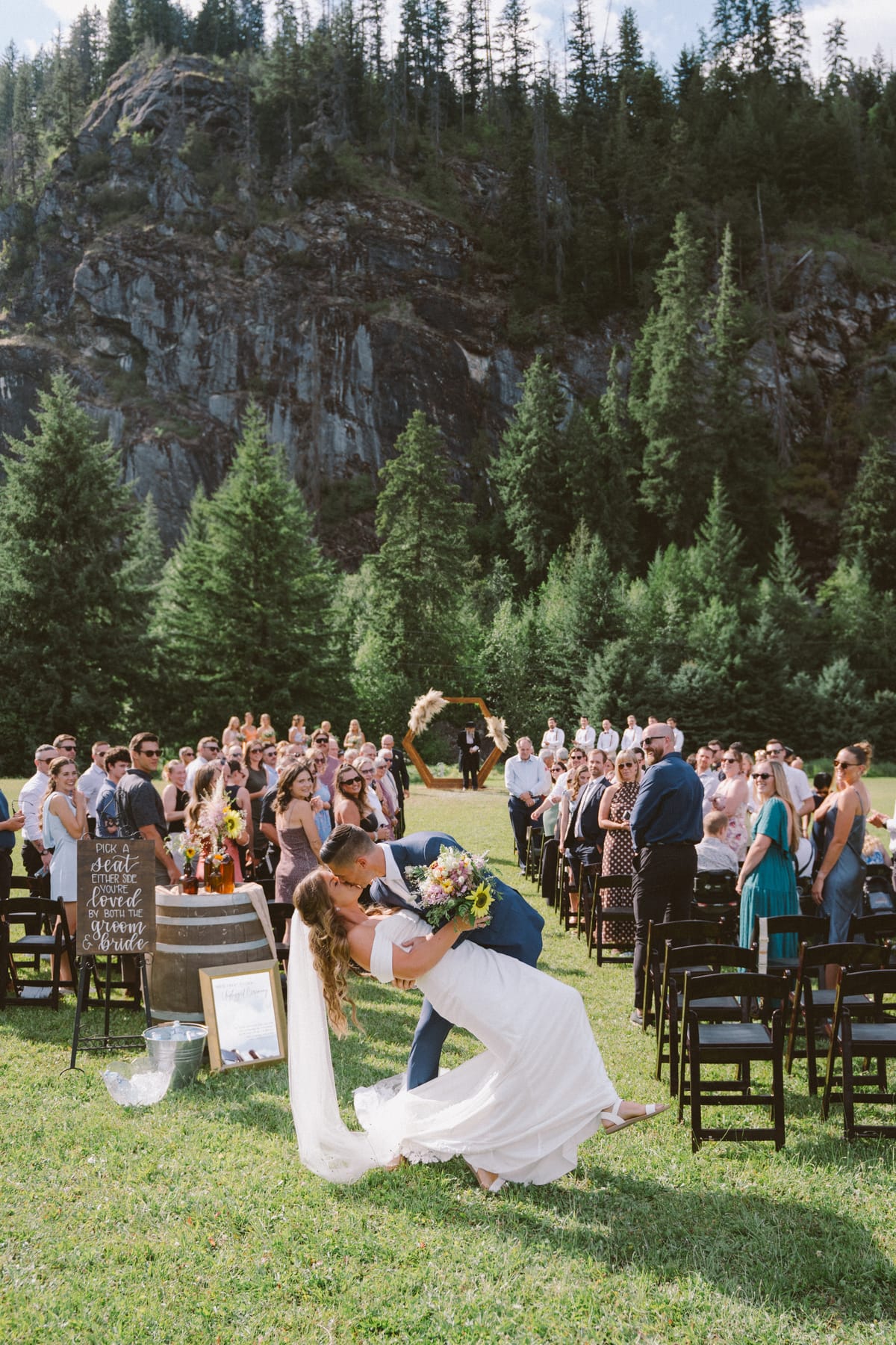 Rory dipping Kendra for a kiss at the back of the aisle as guests stand and cheer