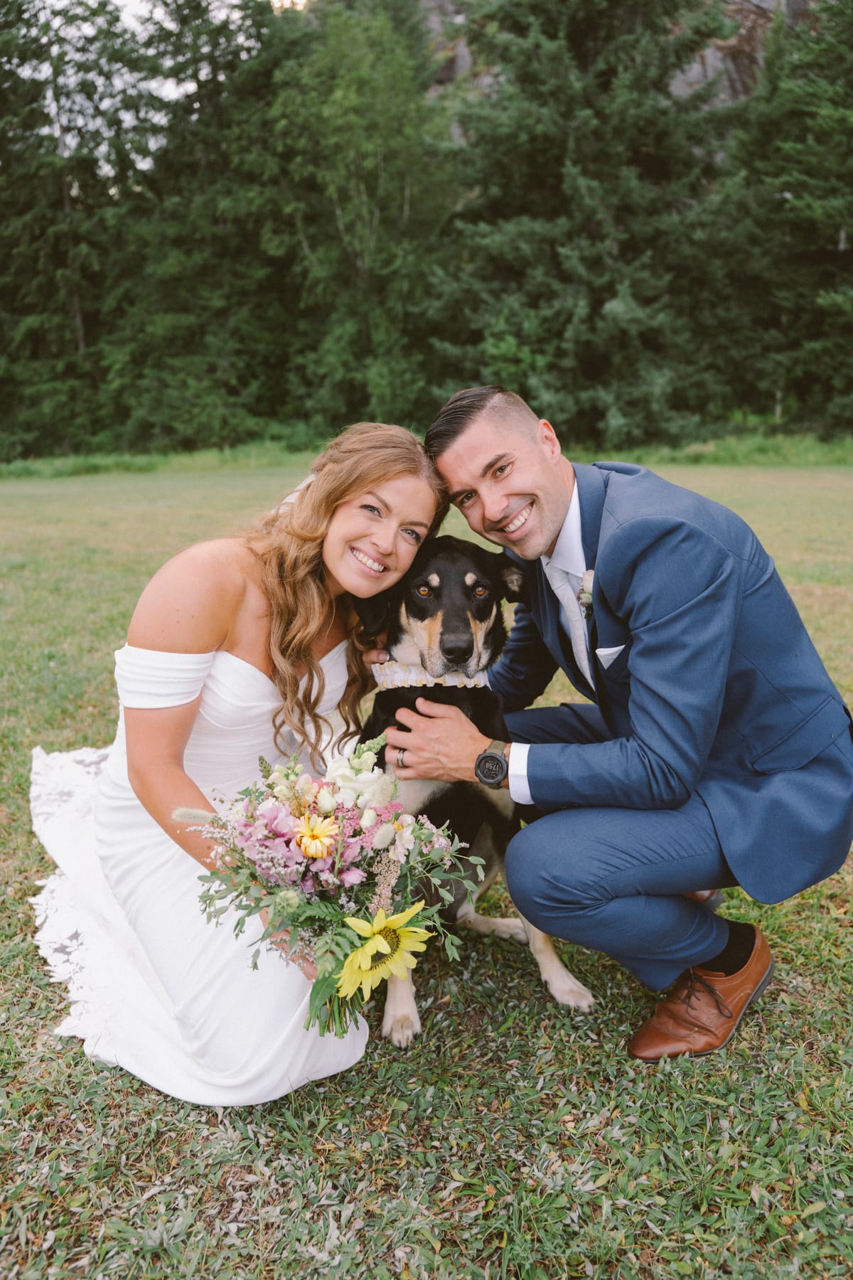 Kendra and Rory crouched with their dog and her wildflower bouquet