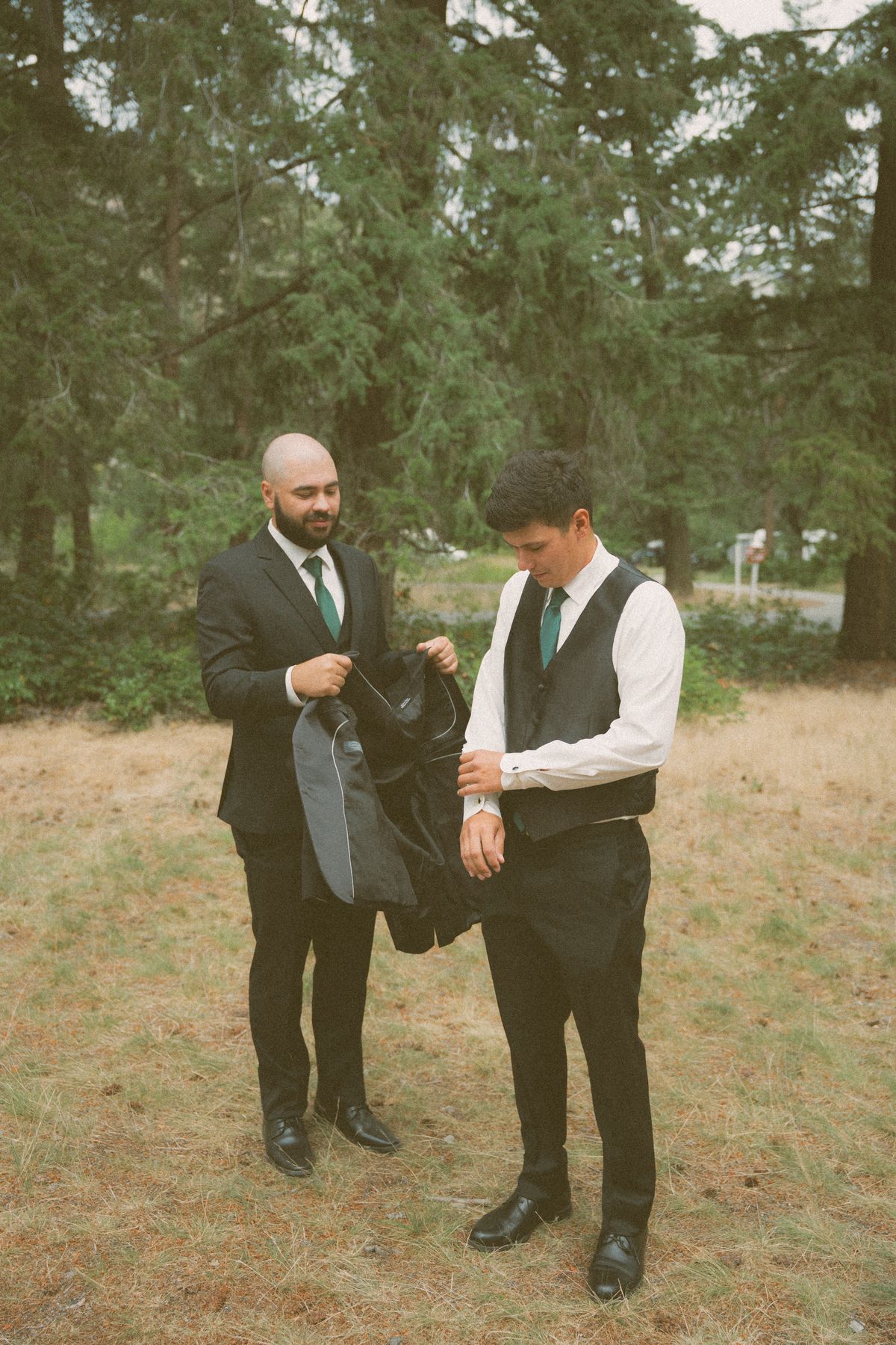 Groom and a groomsman getting ready on the lawn outside Fintry Manor House