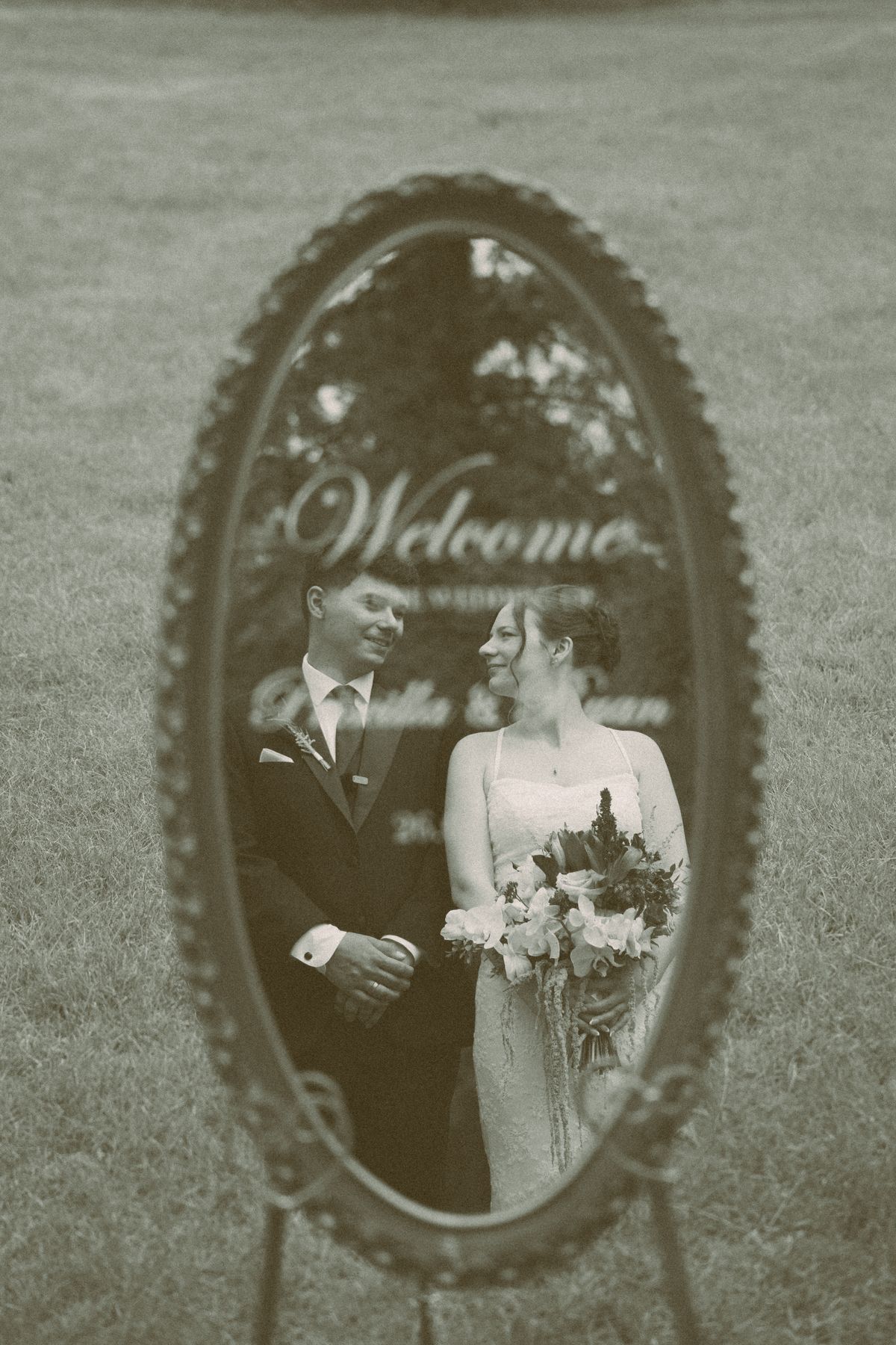 Bride reflected in the oval welcome mirror at the manor