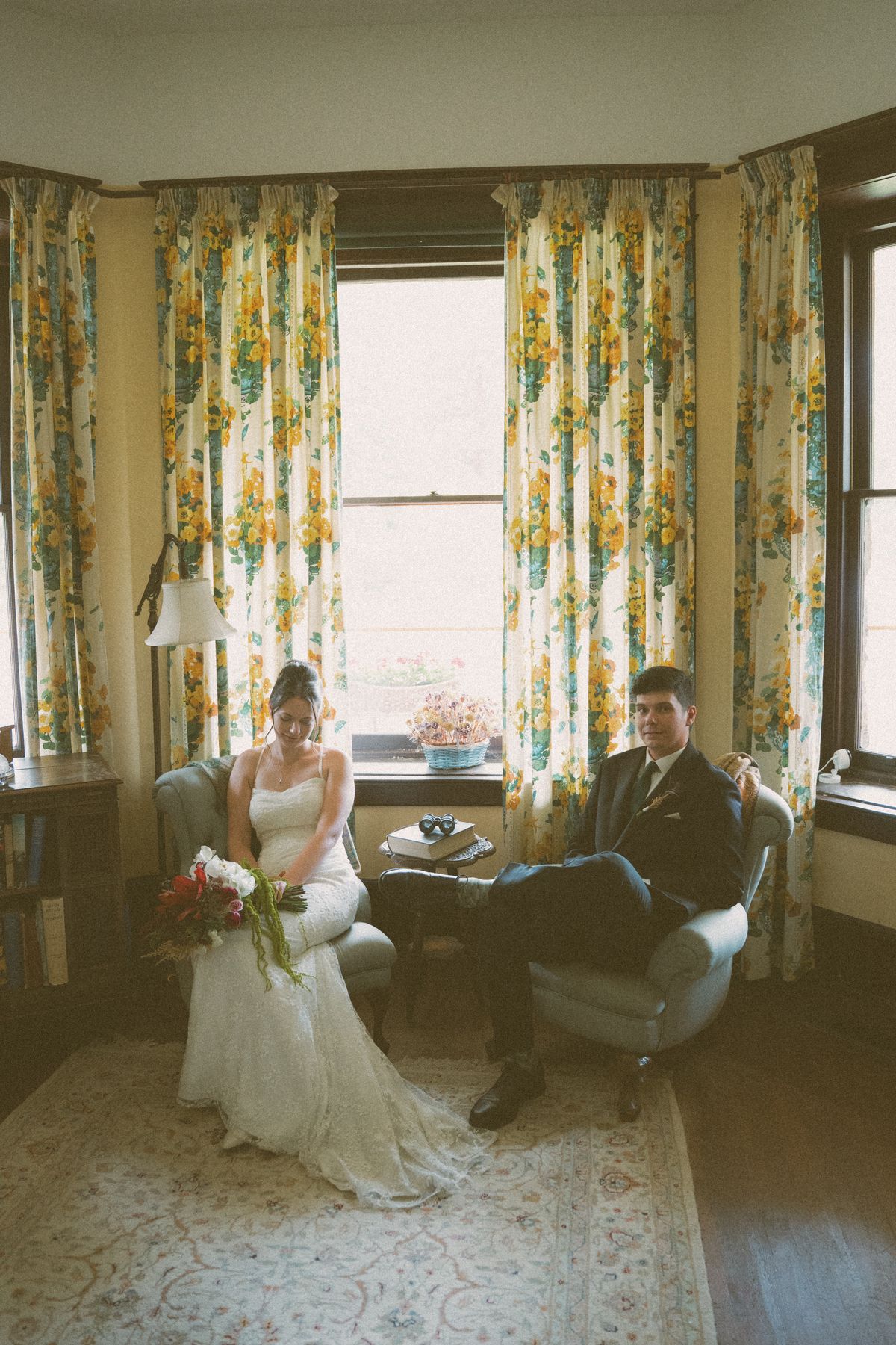 Editorial portrait of the couple in the manor's sitting room