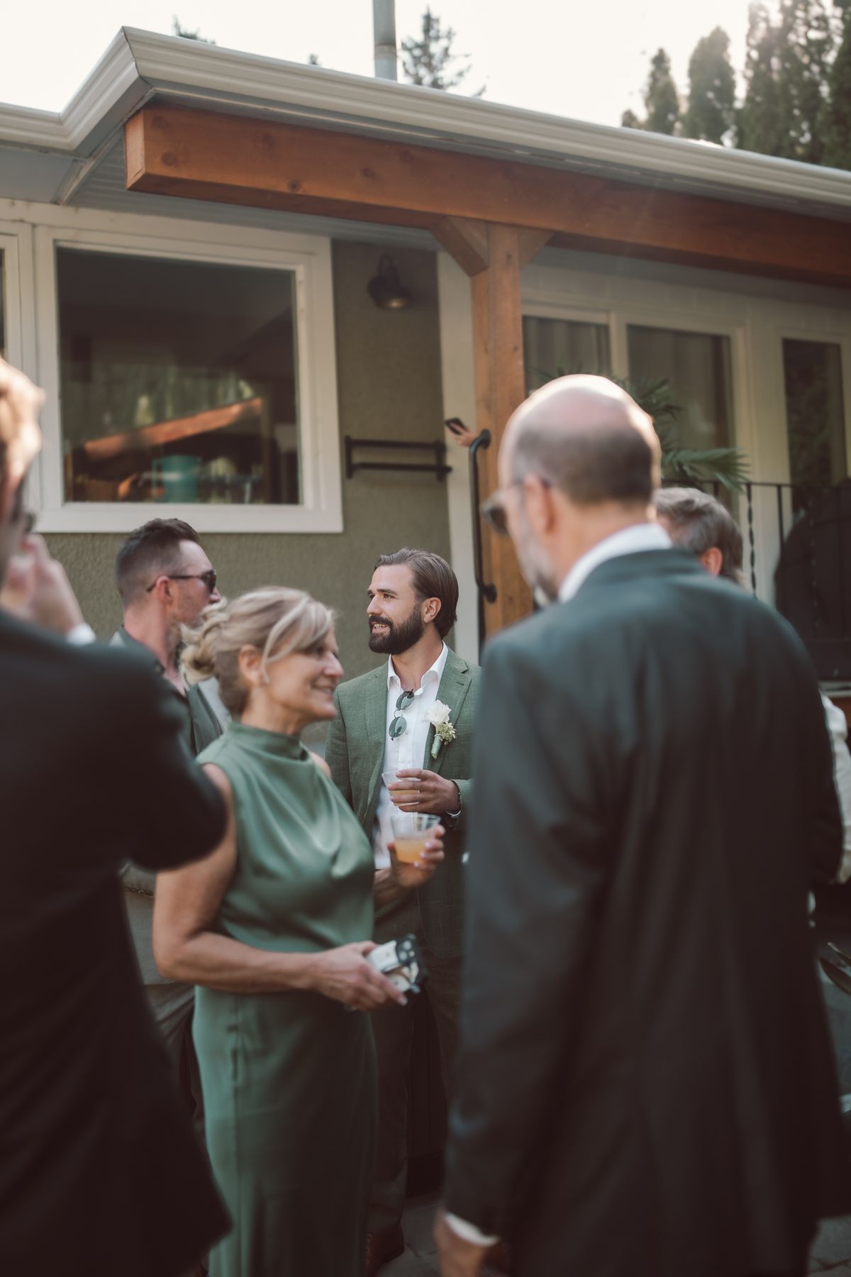 Guests mingling by the house before the ceremony