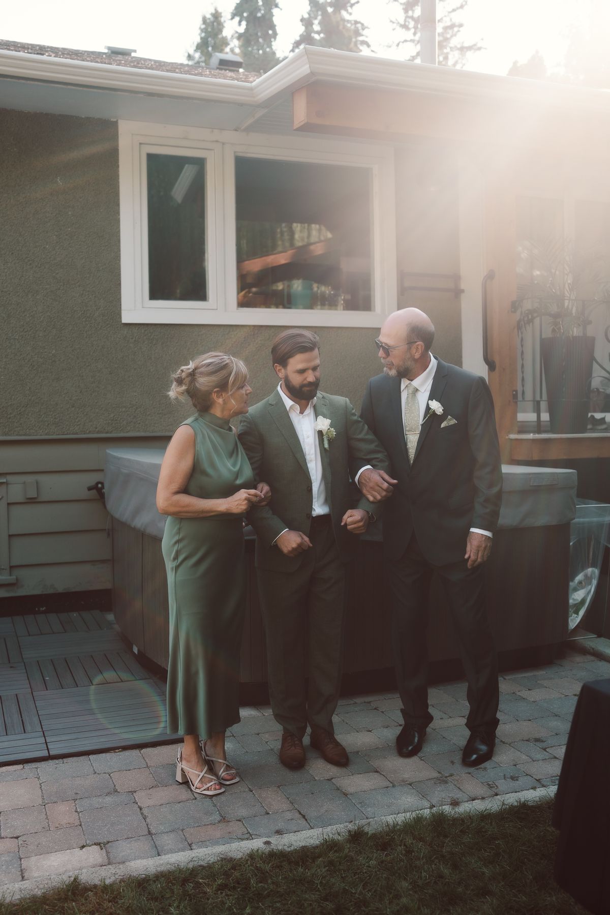 A bridesmaid in sage and guests in the golden afternoon light