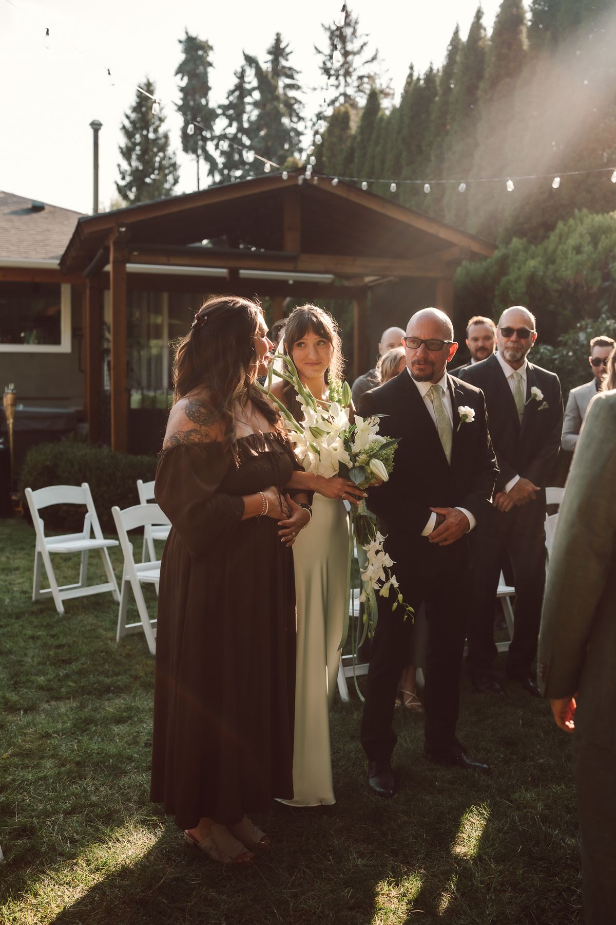 Bride walking in for the ceremony, backlit by the low sun
