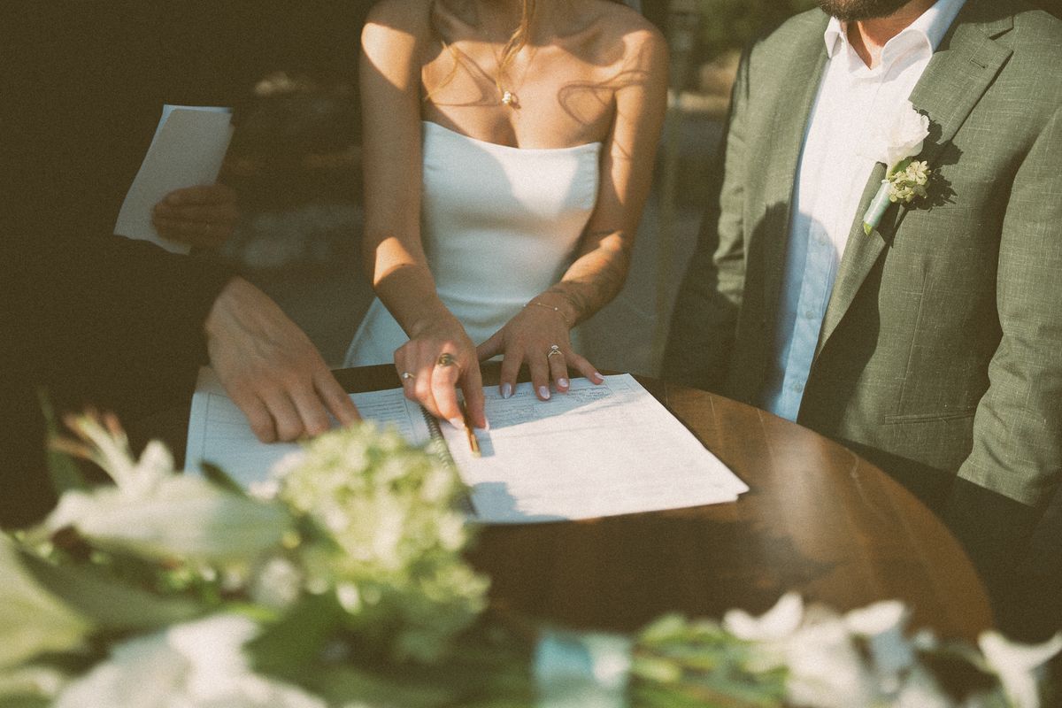 The couple signing their marriage certificate