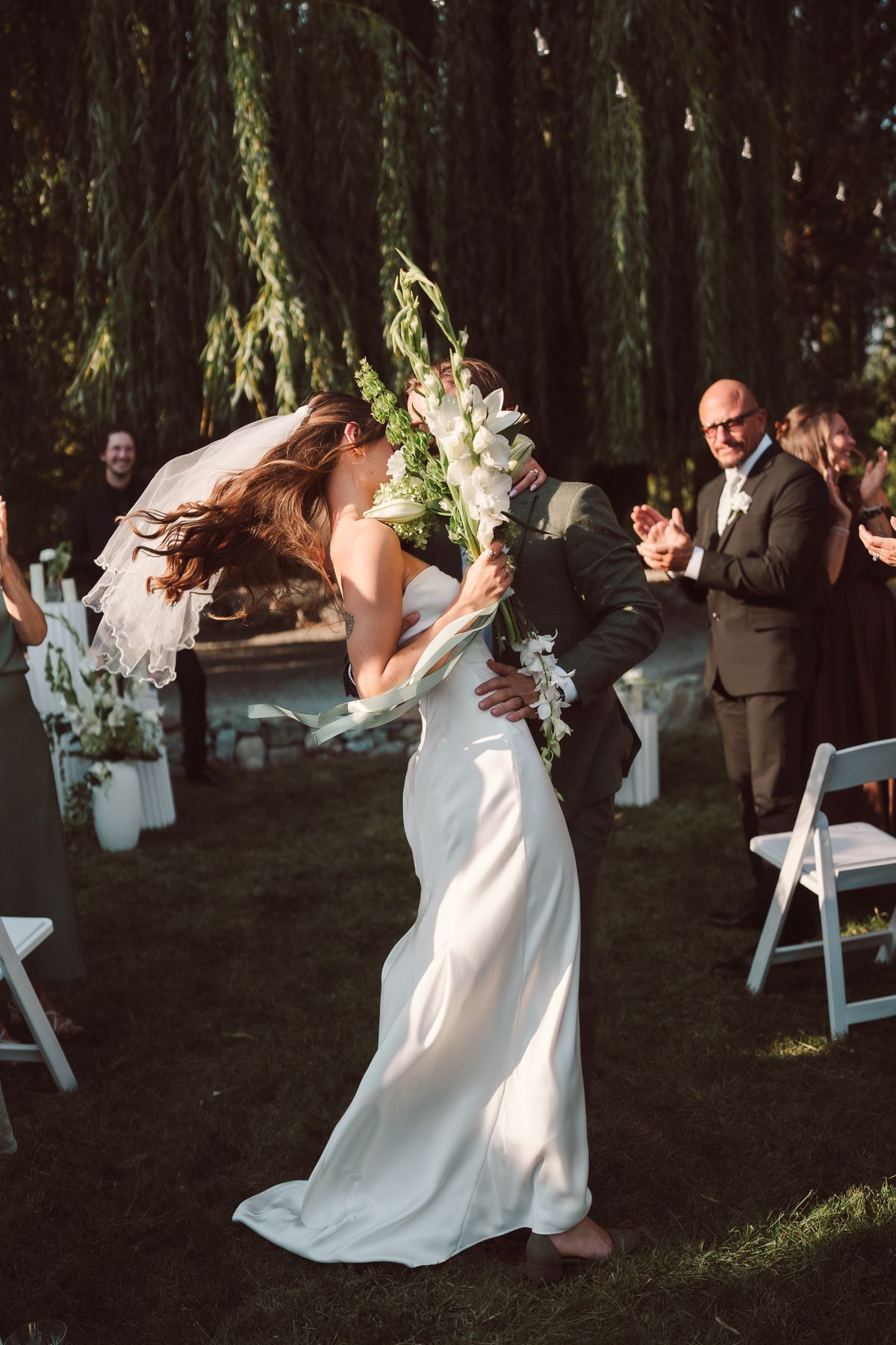 Bride walking back up the aisle with her bouquet