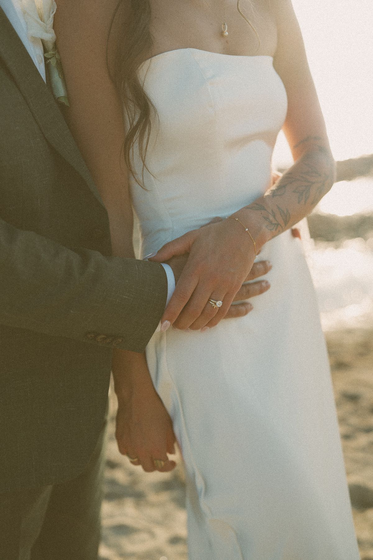 Detail of the groom's hand at the bride's waist