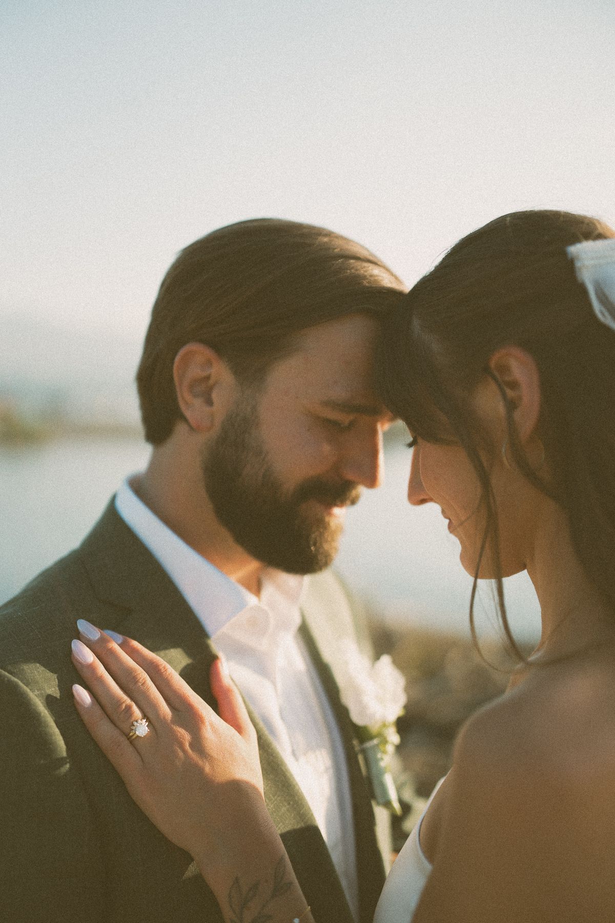 The couple close together in a burst of sun flare
