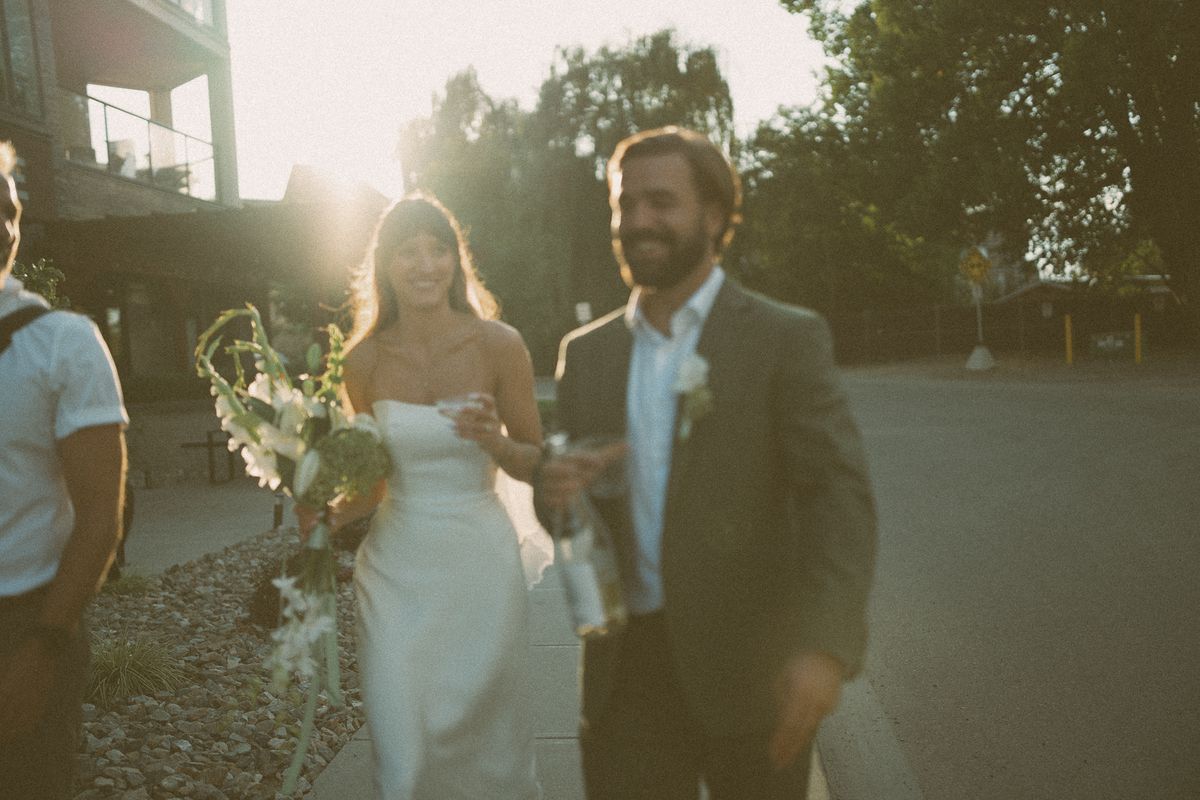 The couple walking toward camera in the sunset light