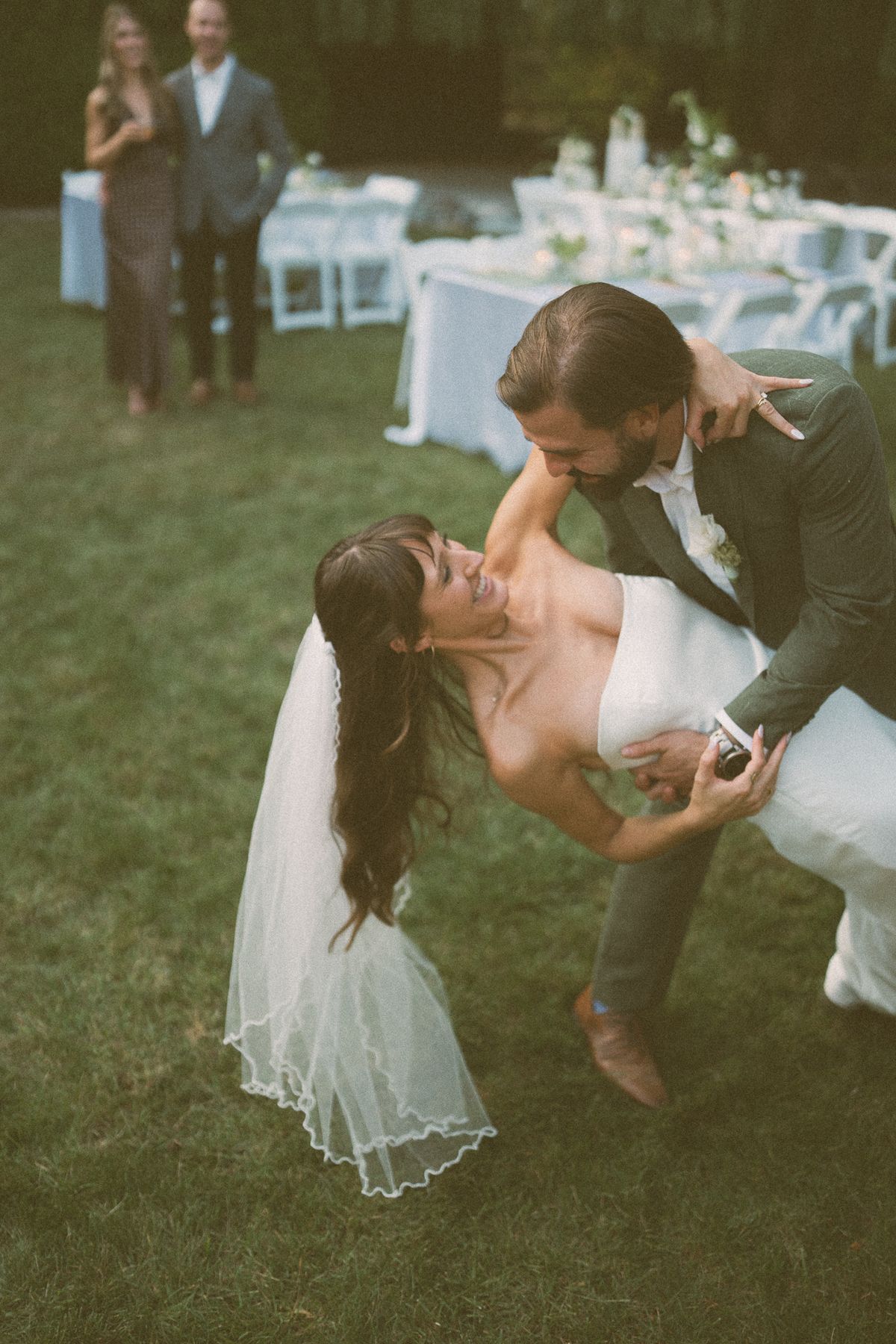Mariah and Ryan's first-dance dip beneath the string lights