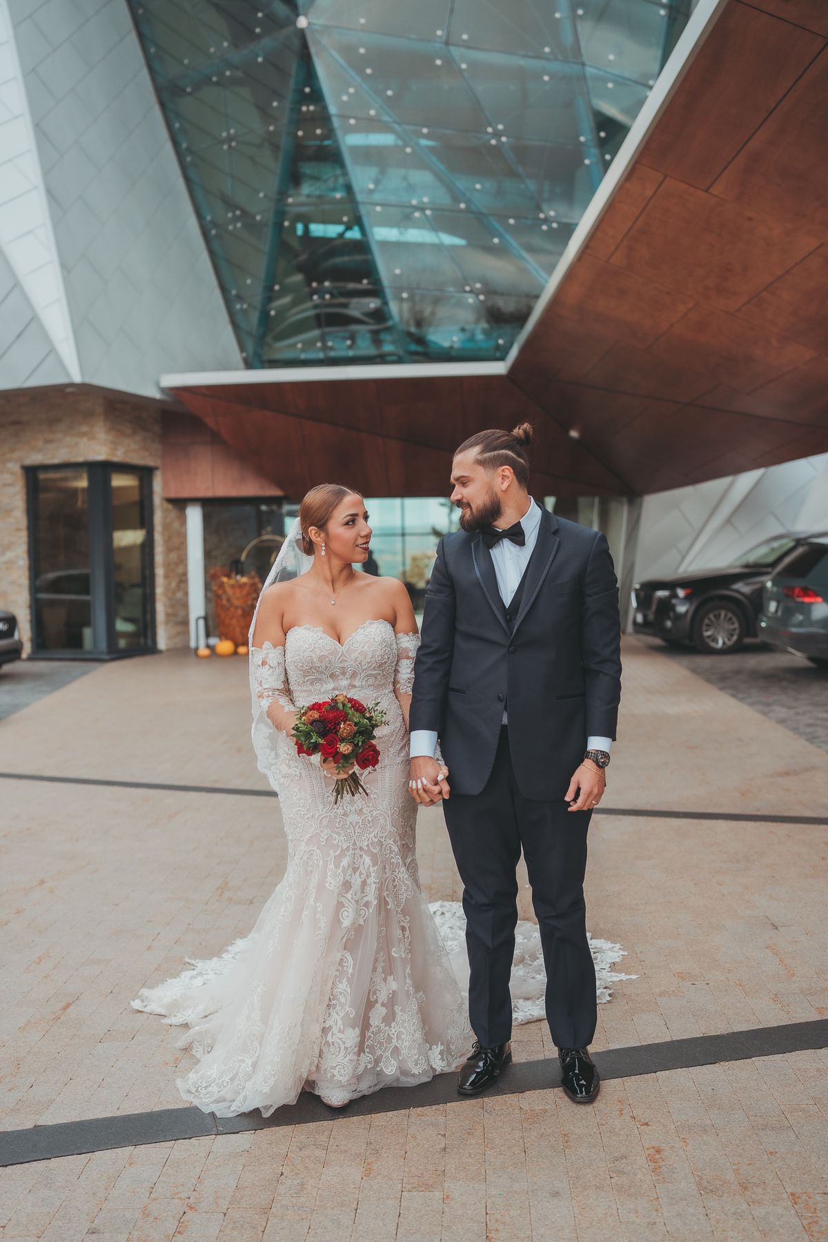 Bride and groom in front of the modern architecture of Sparkling Hill Resort