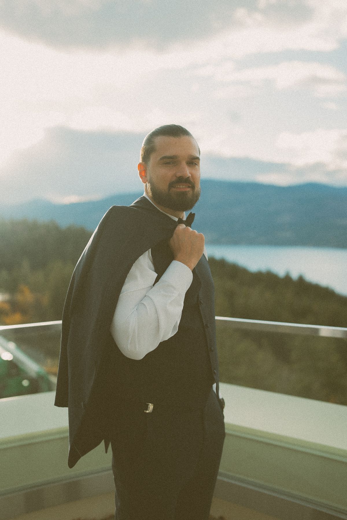Portrait of the groom on the terrace with the lake beyond