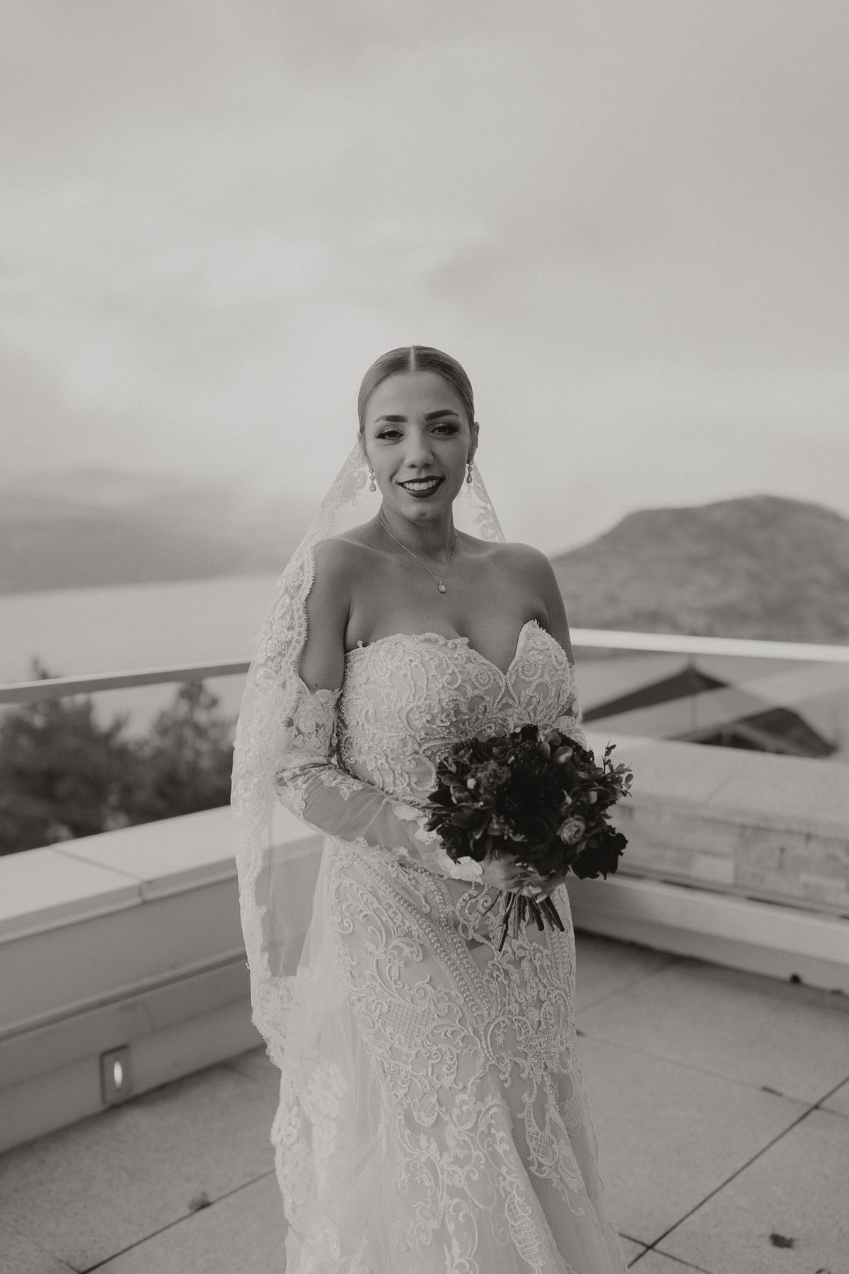 Bride on the rooftop terrace at Sparkling Hill Resort with her bouquet