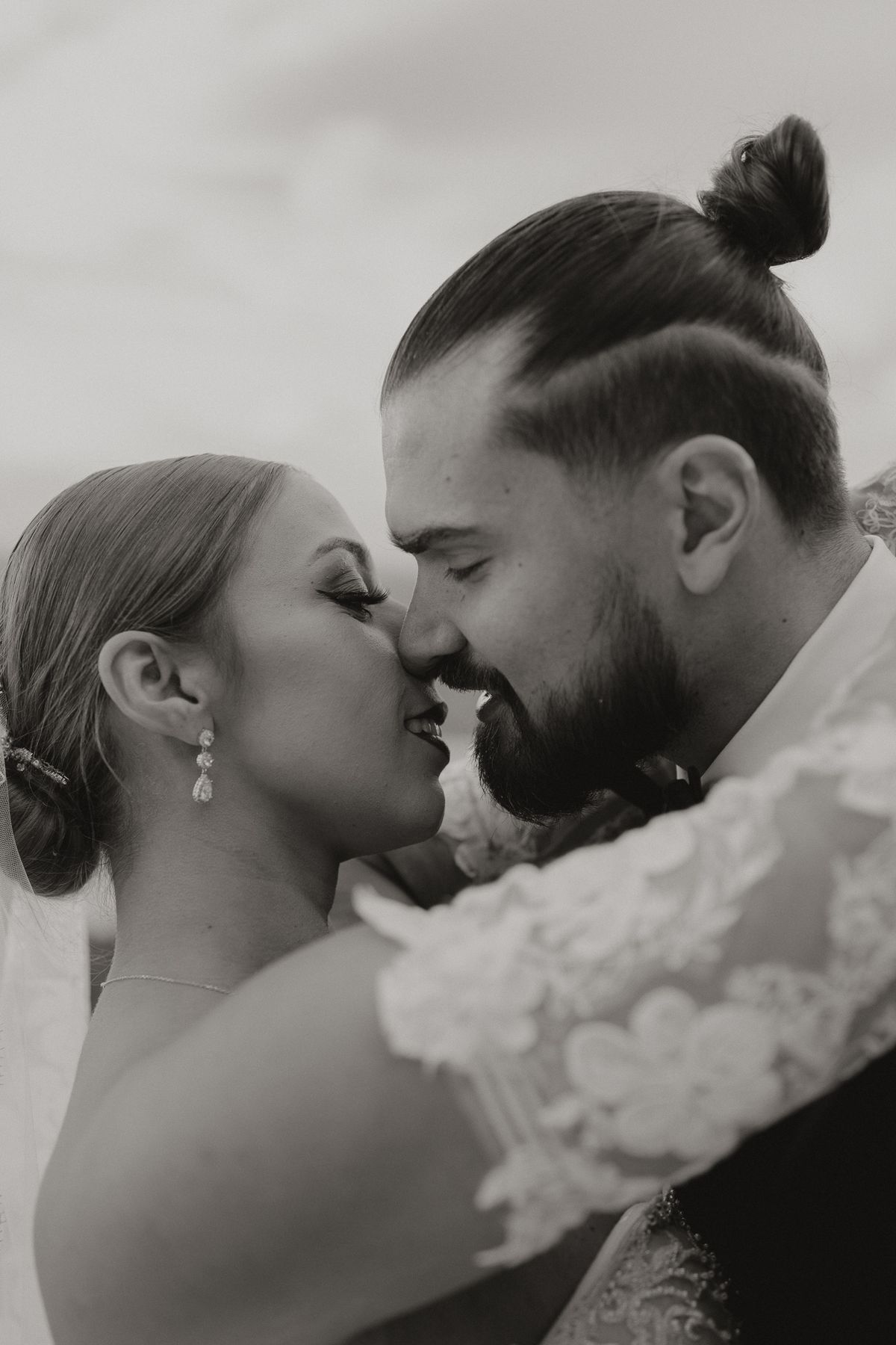 Black and white of the couple sharing a kiss