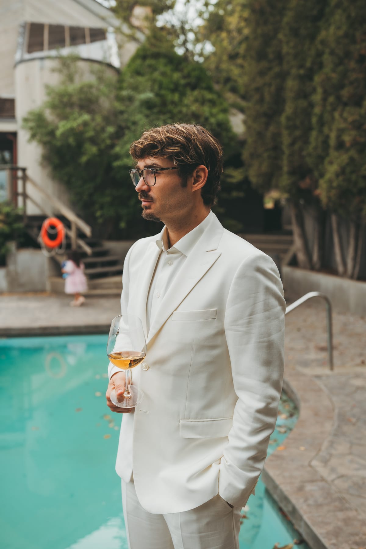 Brandon with a drink by the pool at the winery