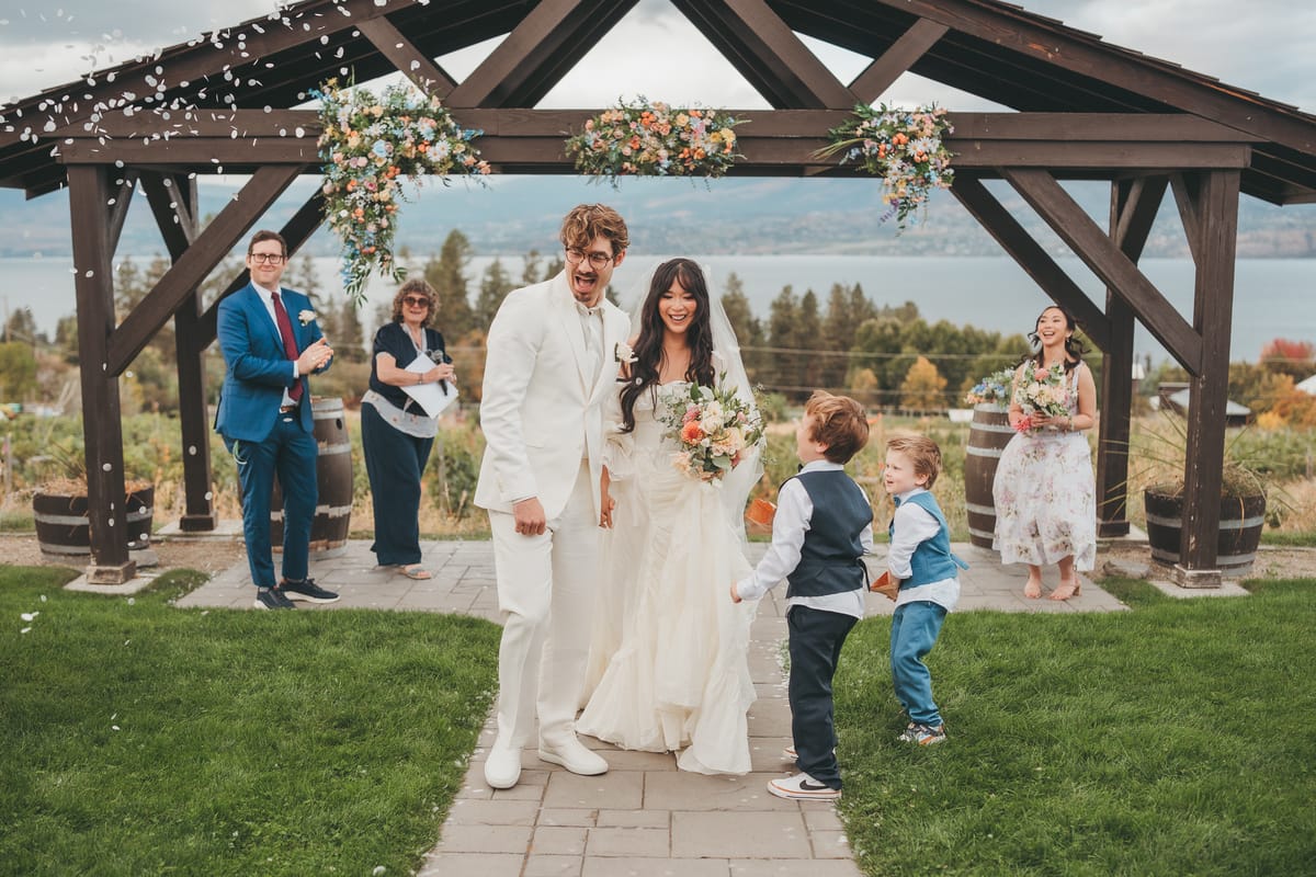 The recessional as Nina and Brandon walk back through a shower of petals to cheering guests