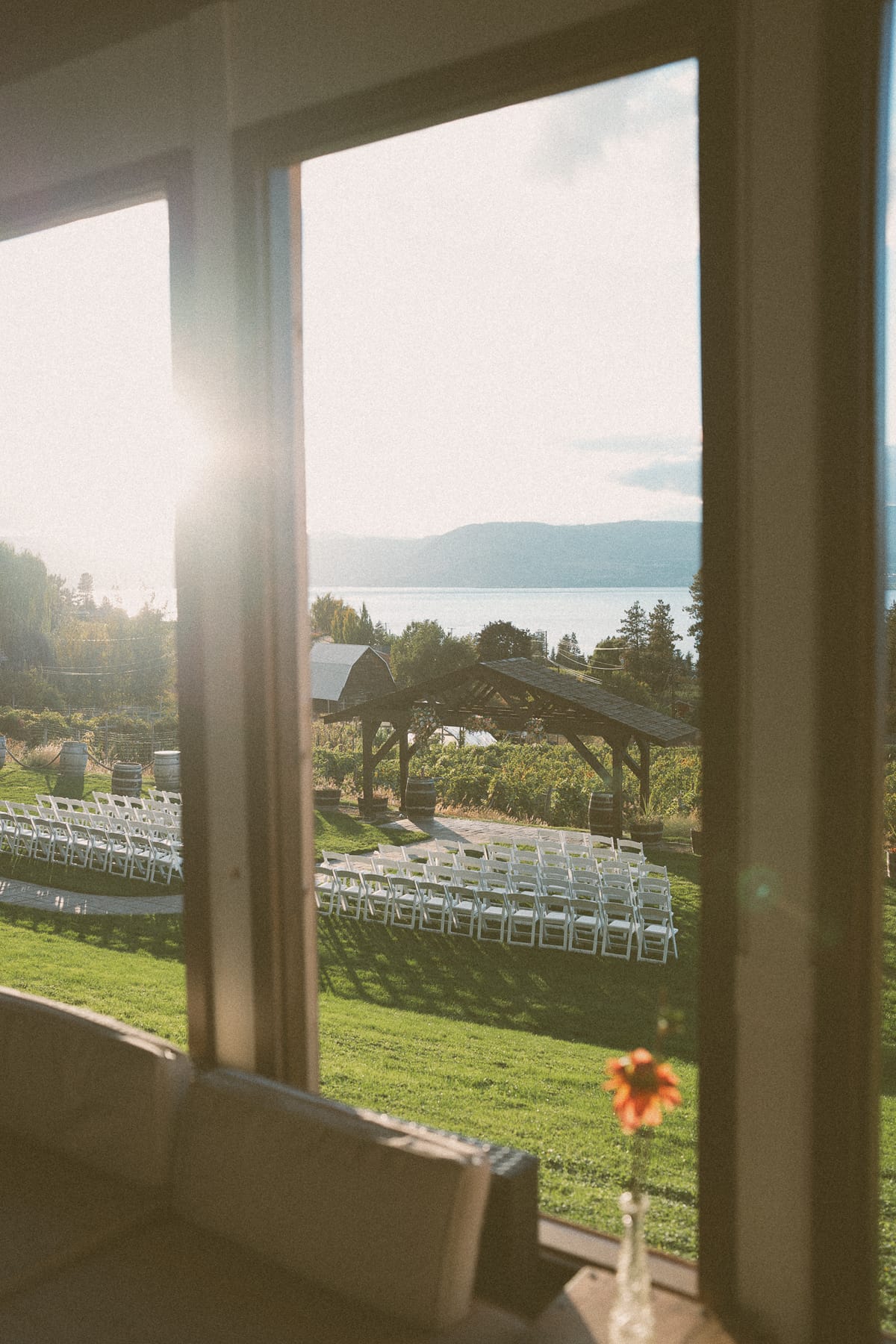 Window light over the vineyard and ceremony lawn toward Okanagan Lake