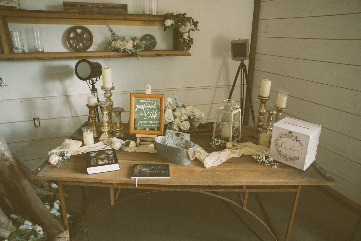 Memory table with framed photos and candles at the reception