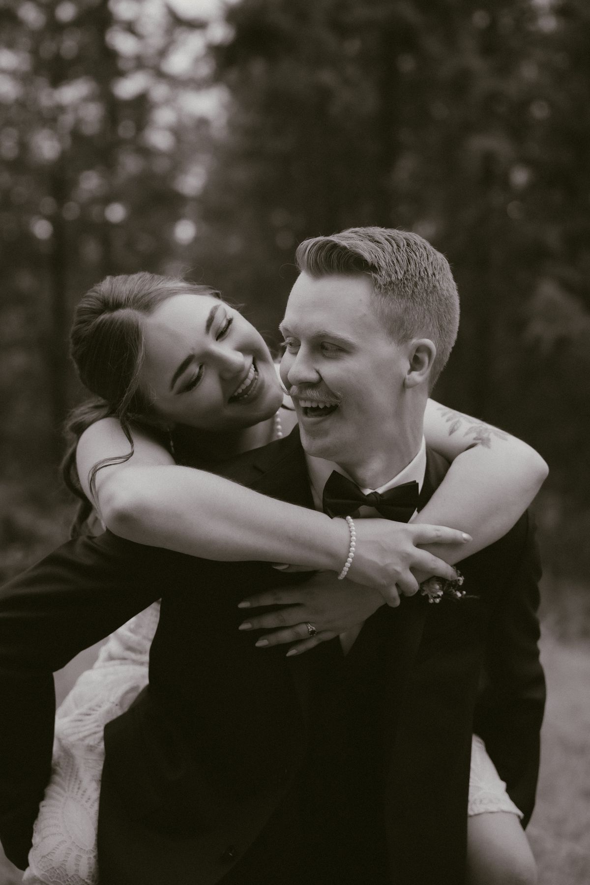 Black and white of the couple laughing together