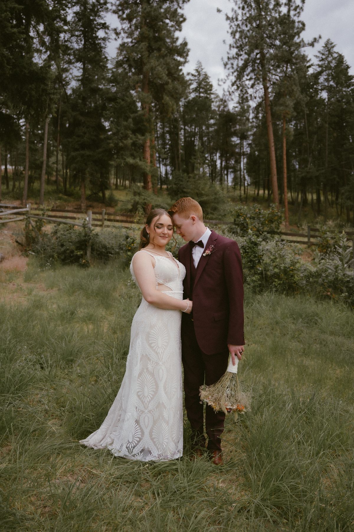 The couple embracing on a forest path at the farm